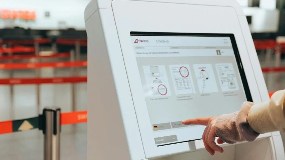 Customer using a self-service kiosk for check-in and support automation.
