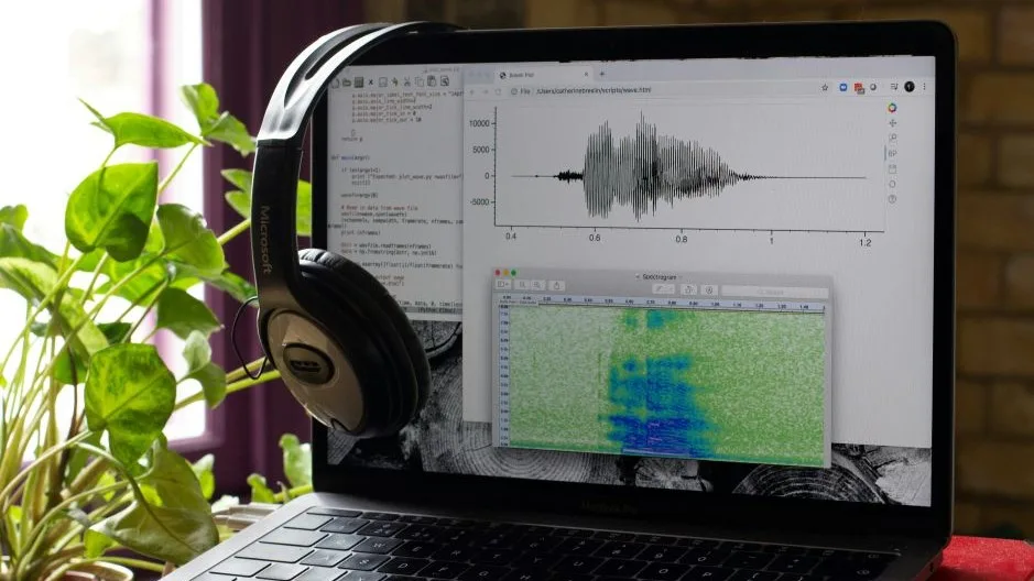Voice AI becomes a core channel: Voice AI customer support on laptop with headset, waveform, and speech analytics screen