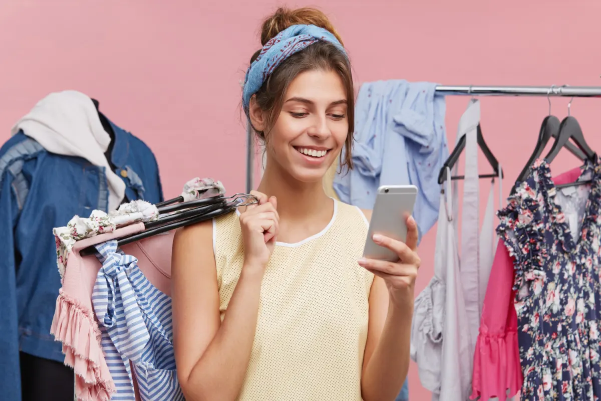 A shopper browsing a fashion store on her phone